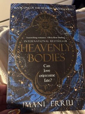 Heavenly Bodies by Imani Erriu — Blue & Gold Paperback Novel